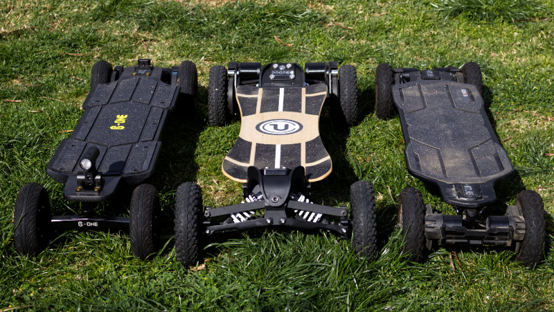 Three Off-road electric skateboards side-by-side