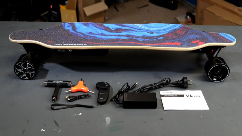 box contents of possway v4 pro containing electric skateboard, t-tool, y-tool, usb-c cable, remote control, charger and user manual.